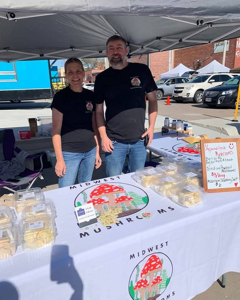 Midwest Mushroom owners at Farmers Market stand